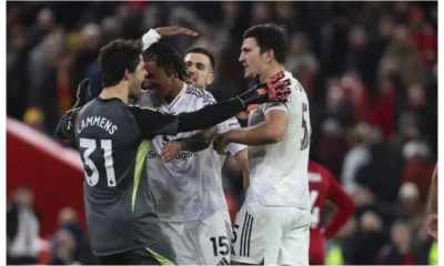 Manchester United players celebrating after a 2-1 victory over Liverpool at Anfield.