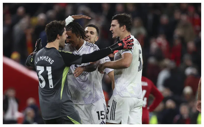 Manchester United players celebrating after a 2-1 victory over Liverpool at Anfield.