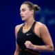 Aryna Sabalenka celebrates after defeating Rebecca Sramkova in a three-set comeback win at the Wuhan Open 2025.