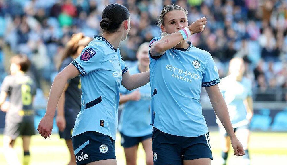 Manchester City defender Kerstin Casparij celebrating a goal wearing rainbow armband