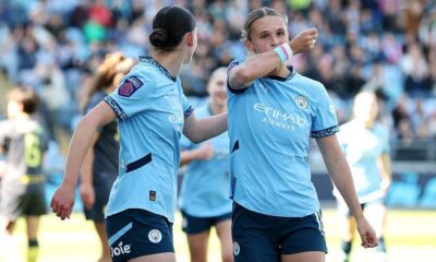 Manchester City defender Kerstin Casparij celebrating a goal wearing rainbow armband