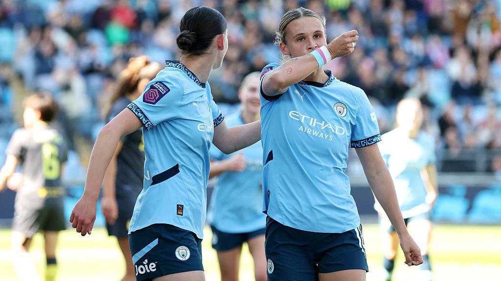 Manchester City defender Kerstin Casparij celebrating a goal wearing rainbow armband
