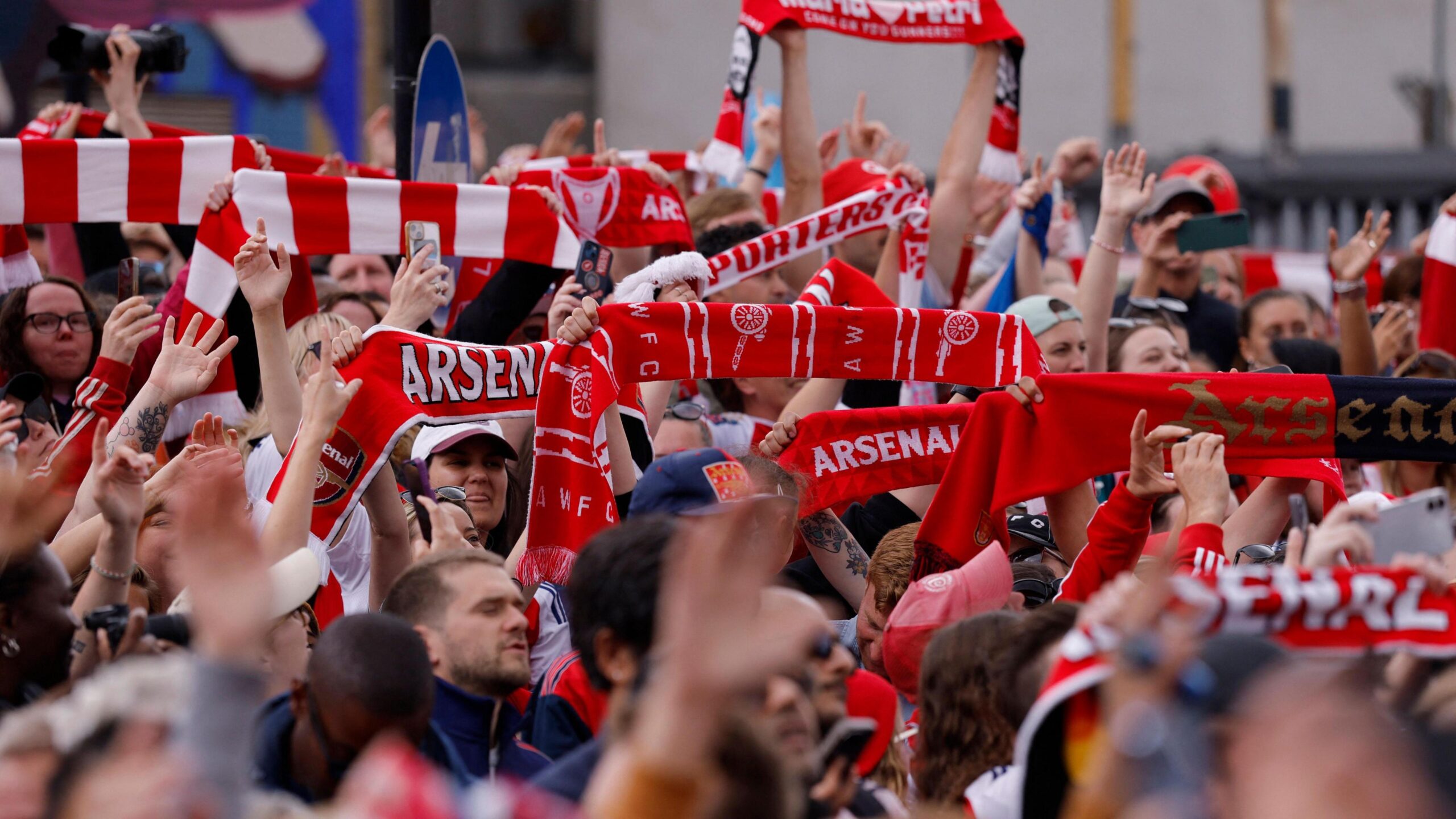 Arsenal fans cheering during a match at the Emirates Stadium