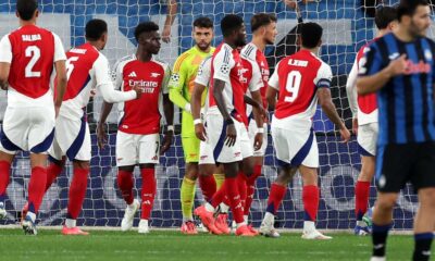 David Raya celebrating Arsenal’s Champions League win with teammates.