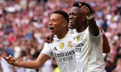 Kylian Mbappe and Vinicius Jr celebrating a goal together for Real Madrid.