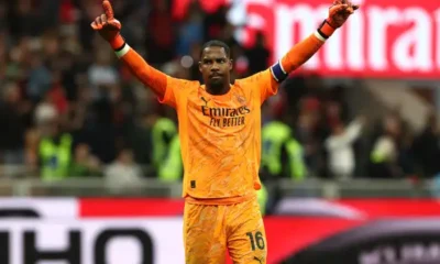 "AC Milan goalkeeper Mike Maignan prepares to make a save as Juventus, Chelsea, and Bayern Munich battle for his signature in the transfer market."