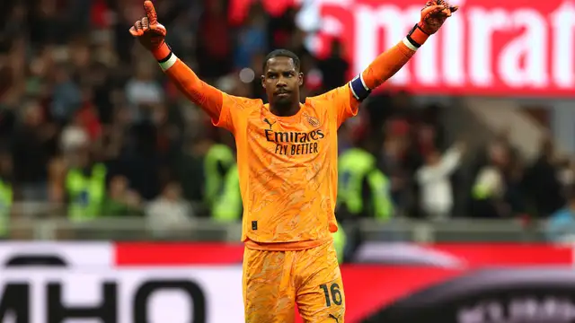 "AC Milan goalkeeper Mike Maignan prepares to make a save as Juventus, Chelsea, and Bayern Munich battle for his signature in the transfer market."