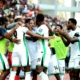 William Troost-Ekong celebrating with Super Eagles teammates after victory against Benin Republic