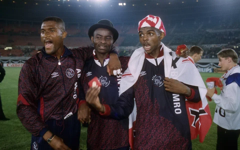 “Nwankwo Kanu wearing Ajax jersey, smiling as he announces return to football with Ajax Legends”