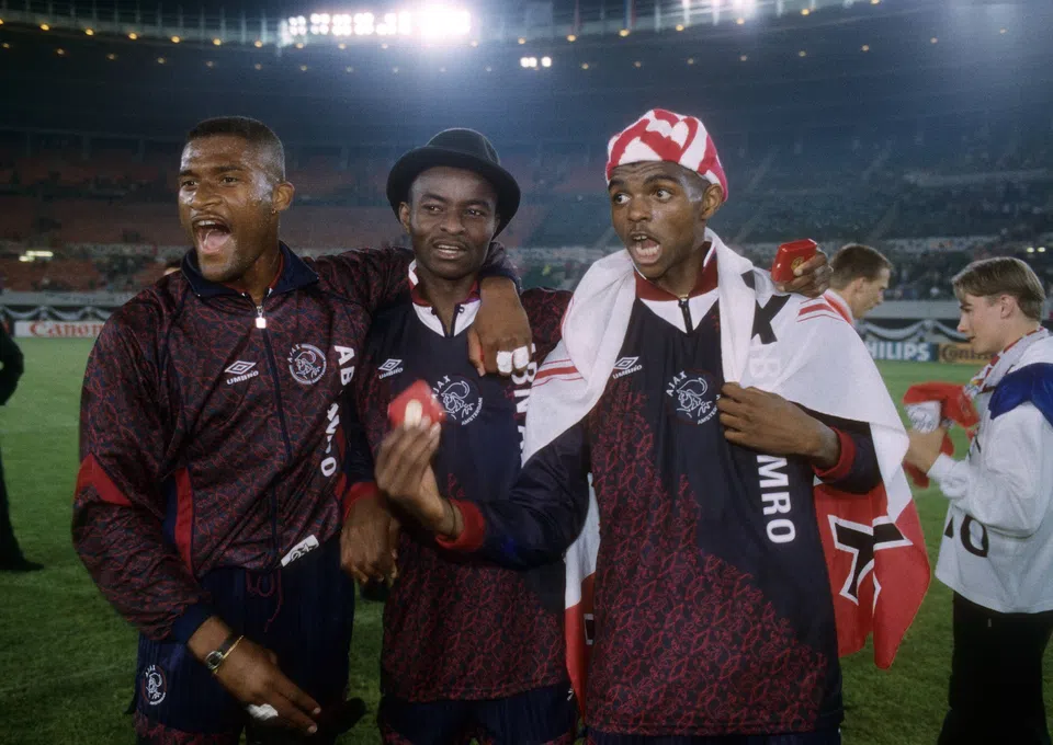 “Nwankwo Kanu wearing Ajax jersey, smiling as he announces return to football with Ajax Legends”