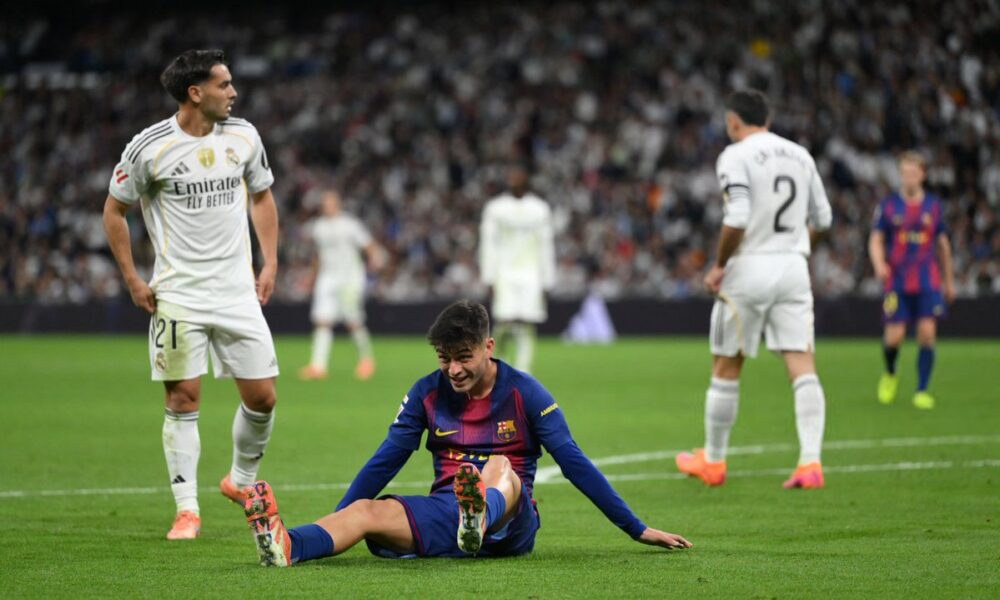 Pedri clutching his leg in pain during Barcelona’s match against Real Madrid