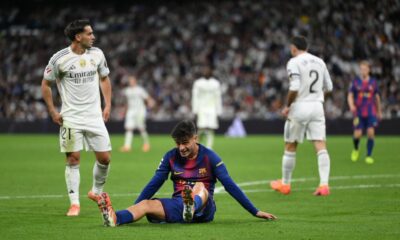 Pedri clutching his leg in pain during Barcelona’s match against Real Madrid