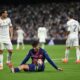 Pedri clutching his leg in pain during Barcelona’s match against Real Madrid