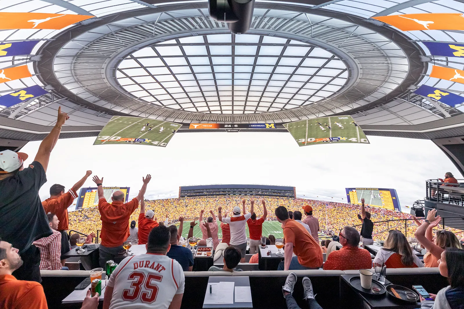 Sports fans cheering in a stadium, representing the global sports market and fan culture.