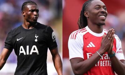 Eden Hazard smiling while watching an Arsenal vs Tottenham match