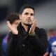 Arsenal manager Mikel Arteta on the sidelines, expressing frustration over fixture congestion during a Premier League match.