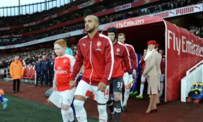 Arsenal players walking out onto the pitch before a Premier League match.