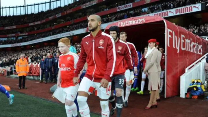 Arsenal players walking out onto the pitch before a Premier League match.