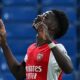 Bukayo Saka celebrating a goal in an Arsenal jersey during a Premier League match.