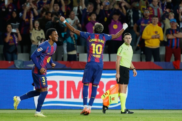 Lamine Yamal celebrates after scoring for Barcelona against Elche in La Liga