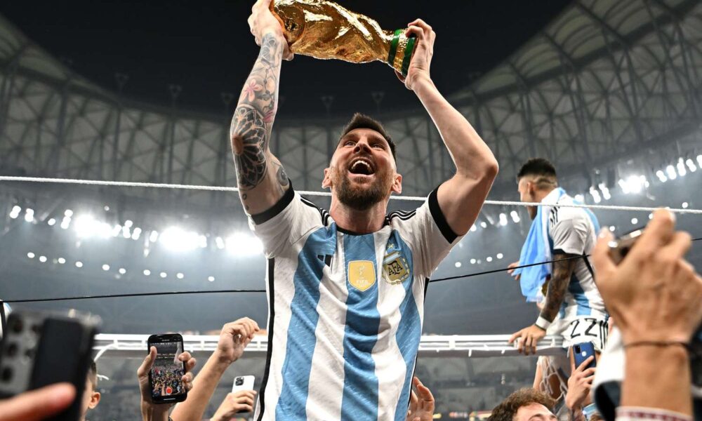 Lionel Messi holding World Cup trophy after Argentina’s 2022 victory