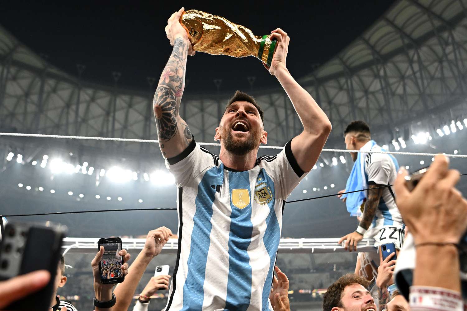 Lionel Messi holding World Cup trophy after Argentina’s 2022 victory