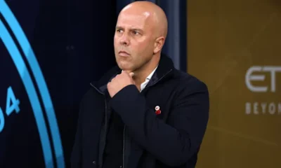 Liverpool manager Arne Slot looks dejected on the sidelines during a Premier League match against Manchester City.