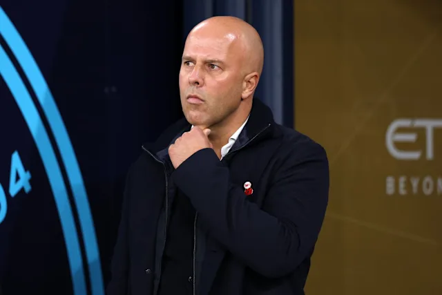 Liverpool manager Arne Slot looks dejected on the sidelines during a Premier League match against Manchester City.