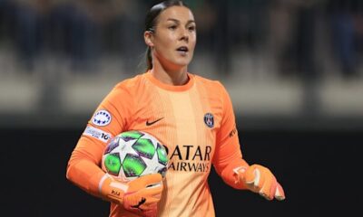 Mary Earps holding a book during an interview after releasing her autobiography