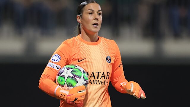 Mary Earps holding a book during an interview after releasing her autobiography