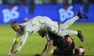 Neymar limping off the pitch during a Santos match