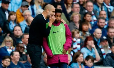 Pep Guardiola giving tactical instructions on the Manchester City touchline.