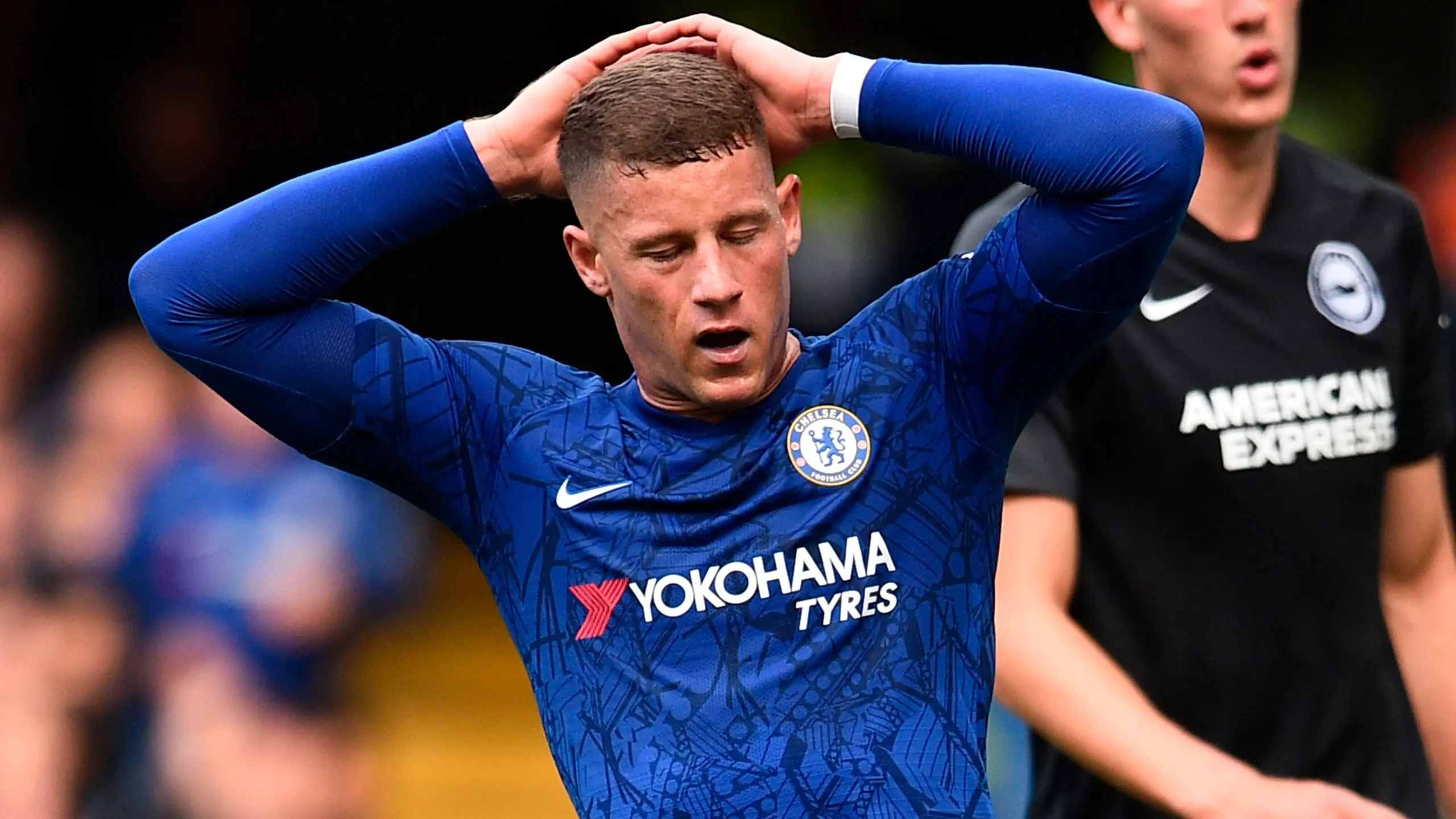 Ross Barkley in a Chelsea jersey looking dejected during a Premier League match at Stamford Bridge.