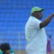 Super Falcons head coach Justine Madugu giving instructions on the sidelines during a match