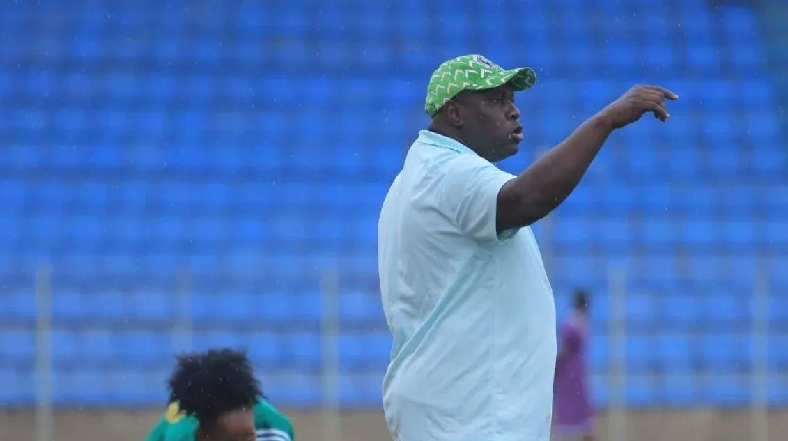Super Falcons head coach Justine Madugu giving instructions on the sidelines during a match