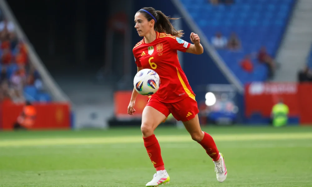Aitana Bonmati holding her leg in pain during a training session for Spain.
