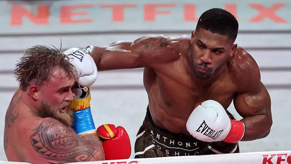 Anthony Joshua delivers a knockout punch to Jake Paul during their six-round boxing match at Miami’s Kaseya Center.