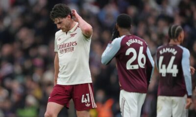 Arsenal players reacting in frustration after conceding a late goal against Aston Villa.