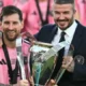 Lionel Messi lifting the MLS Cup trophy with Inter Miami players celebrating.