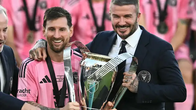 Lionel Messi lifting the MLS Cup trophy with Inter Miami players celebrating.