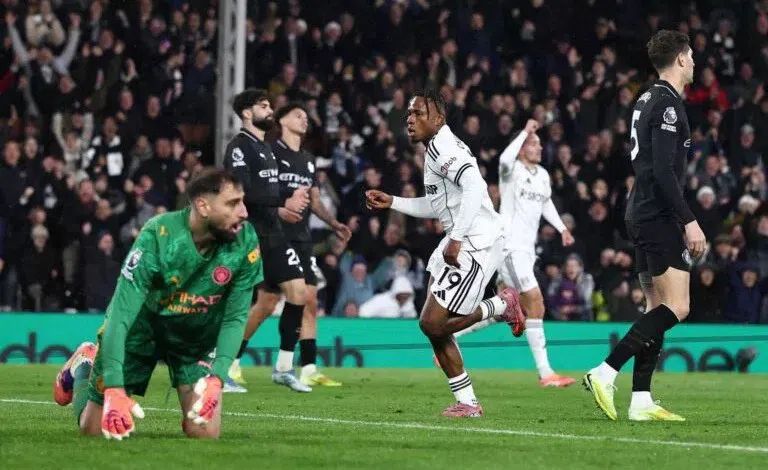 Manchester City defenders reacting during a Premier League match against Fulham.