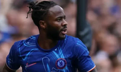 Raheem Sterling looking dejected on the sidelines during a Chelsea match.