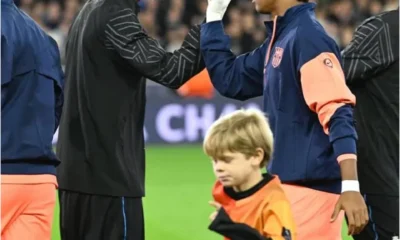 Raphael Onyedika standing during pre-match rituals before a football match.