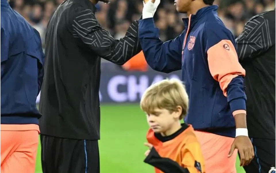 Raphael Onyedika standing during pre-match rituals before a football match.
