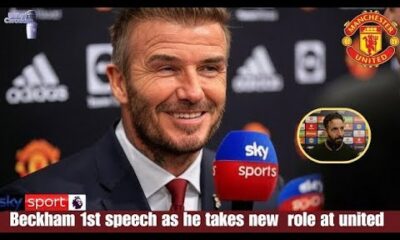 Sir David Beckham watching Manchester United match with thoughtful expression.