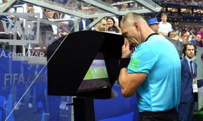 VAR officials reviewing a decision during an international football match.