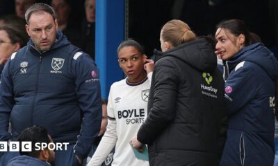Estelle Cascarino warming up for West Ham before being denied debut due to earring