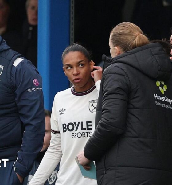 Estelle Cascarino warming up for West Ham before being denied debut due to earring