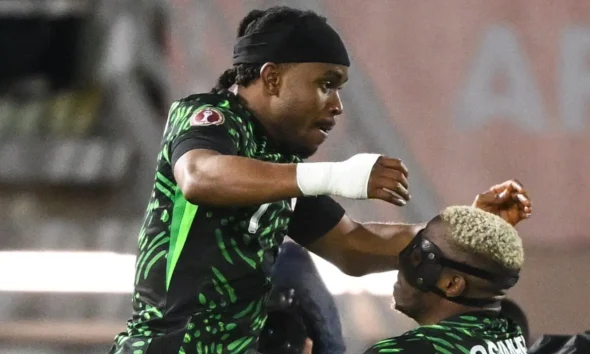 Ademola Lookman celebrating a goal for Nigeria at AFCON 2025 with Super Eagles fans cheering