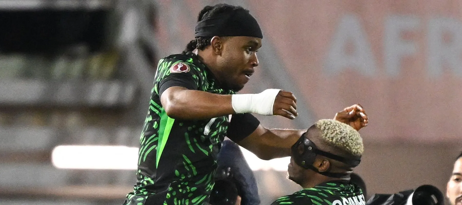 Ademola Lookman celebrating a goal for Nigeria at AFCON 2025 with Super Eagles fans cheering